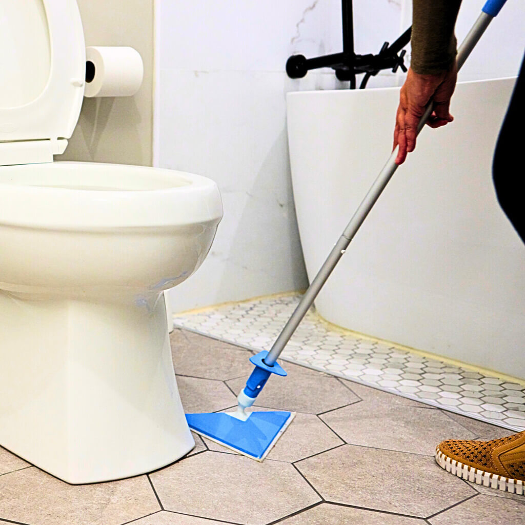 The Pottymop cleaning the floor of a bathroom